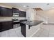 Kitchen area showcasing stainless steel appliances, a large island, and dark cabinetry at 1610 Mohegan Blvd, Kissimmee, FL 34744