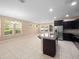 Open-concept kitchen featuring stainless steel appliances, island, and adjacent living area at 1610 Mohegan Blvd, Kissimmee, FL 34744
