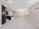 Open-concept living room with tile flooring, recessed lighting, and staircase access at 1610 Mohegan Blvd, Kissimmee, FL 34744