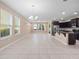Spacious living area with tile flooring, natural light, and open layout into the kitchen at 1610 Mohegan Blvd, Kissimmee, FL 34744