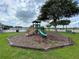 Community playground featuring a slide and climbing structure in a grassy area by the pool at 1610 Mohegan Blvd, Kissimmee, FL 34744