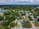 Aerial view shows the property's proximity to a lake, mature trees, neighboring houses, and community at 1625 S Eola Dr, Orlando, FL 32806