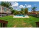 Landscaped backyard with a swimming pool and neatly cut grass at 1625 S Eola Dr, Orlando, FL 32806