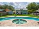 Backyard with in-ground pool, spa, and patio with a shed at 1625 S Eola Dr, Orlando, FL 32806