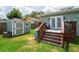 Landscaped backyard features a shed, deck with outdoor seating, grill, and freshly cut grass at 1625 S Eola Dr, Orlando, FL 32806