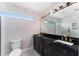 Bright bathroom featuring double vanity, framed mirror, unique light fixture and walk in shower at 1625 S Eola Dr, Orlando, FL 32806