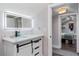 Bathroom featuring an illuminated mirror and vanity, with doorway view to the bedroom at 1625 S Eola Dr, Orlando, FL 32806