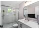 Modern bathroom showcasing shower with glass door, white vanity with a rectangle mirror at 1625 S Eola Dr, Orlando, FL 32806