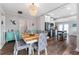 Open concept dining area features stylish chairs, wood floors, and a turquoise cabinet at 1625 S Eola Dr, Orlando, FL 32806