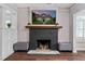 Cozy living room with a black painted brick fireplace and mantle with a TV on the wall at 1625 S Eola Dr, Orlando, FL 32806