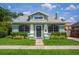 Charming green bungalow with manicured lawn, inviting entrance, and beautiful landscaping at 1625 S Eola Dr, Orlando, FL 32806