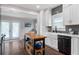 This kitchen features an island, white cabinets, subway tiles, and backyard access at 1625 S Eola Dr, Orlando, FL 32806