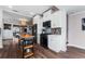 Open plan kitchen featuring stainless appliances, island, hardwood floors, and bright white cabinets at 1625 S Eola Dr, Orlando, FL 32806