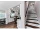 Modern kitchen and staircase featuring white cabinets, stainless steel appliances, and hardwood floors at 1625 S Eola Dr, Orlando, FL 32806