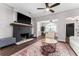 Cozy living room featuring hardwood floors, a fireplace, and seamless transition to dining and living areas at 1625 S Eola Dr, Orlando, FL 32806