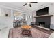 Bright living room with dark wood floors, fireplace, and seamless transition to dining area at 1625 S Eola Dr, Orlando, FL 32806
