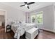 Light-filled main bedroom features a plush bed, hardwood floors, and a storage chest at 1625 S Eola Dr, Orlando, FL 32806
