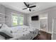 Light-filled main bedroom features ensuite bath, plush bed, and a modern ceiling fan at 1625 S Eola Dr, Orlando, FL 32806