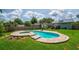 Relaxing backyard featuring pool and a spa surrounded by greenery at 1625 S Eola Dr, Orlando, FL 32806