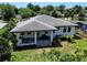Aerial shot of the home featuring an outdoor kitchen and dining area and well-maintained landscaping at 1821 Windsor Dr, Winter Park, FL 32789