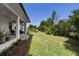 The backyard has a covered patio with a dining area and ample green space for gardening at 1821 Windsor Dr, Winter Park, FL 32789
