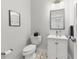 Charming powder room featuring neutral wall, vanity, patterned floor, and stylish fixtures at 1821 Windsor Dr, Winter Park, FL 32789