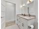 Elegant bathroom featuring double sinks, white cabinetry, and stylish mosaic tile flooring at 1821 Windsor Dr, Winter Park, FL 32789