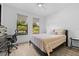Bright bedroom with two windows providing ample natural light and wood-look tile flooring at 1821 Windsor Dr, Winter Park, FL 32789