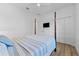 Well-lit bedroom featuring a 4-poster bed, with a television and dual closets at 1821 Windsor Dr, Winter Park, FL 32789