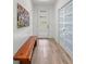 Bright entryway featuring wood-look tile flooring, a modern door with glass panels, and a stylish bench at 1821 Windsor Dr, Winter Park, FL 32789