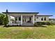The backyard has an outdoor kitchen and dining area with stone steps and manicured landscaping at 1821 Windsor Dr, Winter Park, FL 32789
