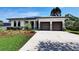 Contemporary home featuring a well-manicured lawn, a two-car garage, and modern design, creating an inviting curb appeal at 1821 Windsor Dr, Winter Park, FL 32789