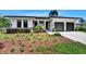 Modern home featuring a manicured front lawn, a two-car garage, solar panels, and sleek design, enhancing curb appeal at 1821 Windsor Dr, Winter Park, FL 32789