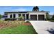 Beautifully landscaped front yard complements this stylish home with a two-car garage, enhancing its welcoming curb appeal at 1821 Windsor Dr, Winter Park, FL 32789