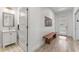 Hallway featuring bathroom with vanity, wood bench, and front door at 1821 Windsor Dr, Winter Park, FL 32789
