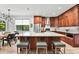 Beautiful kitchen features wood cabinets, stainless appliances, island with seating and marble countertops at 1821 Windsor Dr, Winter Park, FL 32789