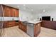 Spacious kitchen with wood cabinets, stainless steel appliances, and island with built-in dishwasher at 1821 Windsor Dr, Winter Park, FL 32789