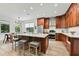 Modern kitchen features wood cabinets, stainless appliances, island with seating and marble countertops at 1821 Windsor Dr, Winter Park, FL 32789