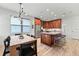 Open floor plan featuring a kitchen with wood cabinets, stainless appliances, island with seating and dining area at 1821 Windsor Dr, Winter Park, FL 32789