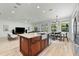Open floor plan featuring a kitchen with stainless appliances, island, living and dining areas at 1821 Windsor Dr, Winter Park, FL 32789