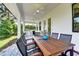 The outdoor dining space features a beautiful wood table and chairs with ceiling fans at 1821 Windsor Dr, Winter Park, FL 32789