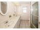 Bathroom featuring dual sinks, a shower with glass door, and vanity at 2 Pirates Cv, Ormond Beach, FL 32176