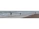 A scenic beach view with people enjoying the ocean waves at 2 Pirates Cv, Ormond Beach, FL 32176