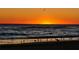 A striking sunset over the ocean with silhouetted birds on the shoreline at 2 Pirates Cv, Ormond Beach, FL 32176