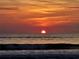 A vivid sunset over the ocean, creating a picturesque beach scene at 2 Pirates Cv, Ormond Beach, FL 32176