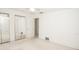 This is a bedroom featuring a ceiling fan, a mirrored closet, white walls and beige carpet at 2 Pirates Cv, Ormond Beach, FL 32176