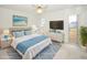 Stylized bedroom with ceiling fan, modern furniture, and beach-themed artwork at 2 Pirates Cv, Ormond Beach, FL 32176