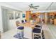 Dining area with seating for six, with an open concept kitchen and view of the outdoor pool at 2 Pirates Cv, Ormond Beach, FL 32176