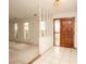 Welcoming tiled entryway with chandelier, wooden door and decorative partition at 2 Pirates Cv, Ormond Beach, FL 32176