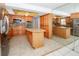 Spacious kitchen with wood cabinets, granite countertops, tile floor, and stainless steel appliances at 2 Pirates Cv, Ormond Beach, FL 32176